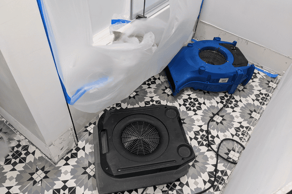 water damage in bathroom with decorative tile- professional drying equipment