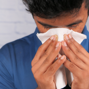 Sick Man from mold Allergy Sneezing and Blowing Nose